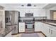 Well-equipped kitchen boasting stainless steel appliances, granite countertops, and ample cabinet space at 474 Lomond Dr, Port Charlotte, FL 33953