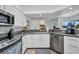 Modern kitchen featuring stainless steel appliances, granite countertops, and white cabinetry at 474 Lomond Dr, Port Charlotte, FL 33953