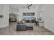Bright and airy living room featuring a comfortable grey sectional sofa and view to the backyard at 474 Lomond Dr, Port Charlotte, FL 33953