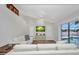 Bright living room with white sofas, a TV, and sliding glass doors leading to the pool at 474 Lomond Dr, Port Charlotte, FL 33953