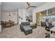 Bright and airy living room featuring a comfortable grey sectional sofa, and view to the dining area at 474 Lomond Dr, Port Charlotte, FL 33953