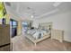 Beautiful bedroom featuring a ceiling fan, patio door, a king-size bed and modern decor at 474 Lomond Dr, Port Charlotte, FL 33953