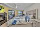 Bedroom featuring a ceiling fan, a king-size bed, and a sliding door leading to the outdoor area at 474 Lomond Dr, Port Charlotte, FL 33953