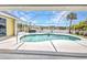 Sparkling screened-in pool and waterfront views, creating a serene outdoor oasis at 474 Lomond Dr, Port Charlotte, FL 33953