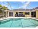 Waterfront pool with beautiful patio and lounge seating at 474 Lomond Dr, Port Charlotte, FL 33953