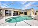 Outdoor pool with seating area, spacious patio, and waterfront views at 474 Lomond Dr, Port Charlotte, FL 33953