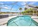 Screened pool with clear water offers backyard and dock views at 474 Lomond Dr, Port Charlotte, FL 33953