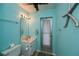 Cozy bathroom with blue walls, walkout door and starfish decoration at 543 Mayview Nw Ave, Port Charlotte, FL 33952