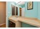 Bathroom with blue walls, vanity with sink, medicine cabinet and decorative seashell picture at 543 Mayview Nw Ave, Port Charlotte, FL 33952