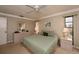 Bright bedroom featuring neutral walls, a ceiling fan, and traditional furnishings for a calm and inviting space at 543 Mayview Nw Ave, Port Charlotte, FL 33952