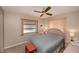 Neutral bedroom featuring a ceiling fan and large window with natural light at 543 Mayview Nw Ave, Port Charlotte, FL 33952