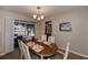 Dining area featuring a chandelier, dining table and sliding glass doors to the pool area at 543 Mayview Nw Ave, Port Charlotte, FL 33952