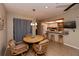 Dining area with views of the open kitchen and a round table with seating at 543 Mayview Nw Ave, Port Charlotte, FL 33952