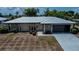 Charming single-story home featuring a metal roof, stone accents, and a convenient attached garage at 543 Mayview Nw Ave, Port Charlotte, FL 33952