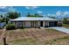 Charming single-story home featuring a metal roof, stone accents, and a convenient attached garage at 543 Mayview Nw Ave, Port Charlotte, FL 33952
