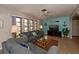 Comfortable living room featuring a ceiling fan and nautical decor at 543 Mayview Nw Ave, Port Charlotte, FL 33952