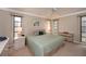 Bright main bedroom features a ceiling fan, neutral paint, and natural light at 543 Mayview Nw Ave, Port Charlotte, FL 33952