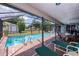 Inviting screened-in pool area with brick pavers, lounge chairs, and dining set at 543 Mayview Nw Ave, Port Charlotte, FL 33952