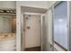 Shower stall showcasing tiled walls, a glass door, and modern showerhead with a window for natural light at 543 Mayview Nw Ave, Port Charlotte, FL 33952