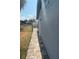 View of the side of the property showcasing the yard and brick pathway at 635 W Tarpon Nw Blvd, Port Charlotte, FL 33952