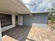 A covered paver patio off the back of the house with a gate to the backyard at 635 W Tarpon Nw Blvd, Port Charlotte, FL 33952