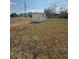 Backyard shed in a large fenced yard provides extra storage at 635 W Tarpon Nw Blvd, Port Charlotte, FL 33952