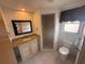 Bright bathroom featuring a granite countertop, ample storage, and tiled walk-in shower at 635 W Tarpon Nw Blvd, Port Charlotte, FL 33952