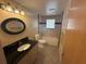 Bathroom with a vanity, black countertop, tile flooring, and bath tub at 635 W Tarpon Nw Blvd, Port Charlotte, FL 33952