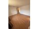 A spacious bedroom with wood-look flooring and ensuite bathroom access at 635 W Tarpon Nw Blvd, Port Charlotte, FL 33952