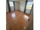 Bright bedroom with wood-look floors, and windows providing exterior views at 635 W Tarpon Nw Blvd, Port Charlotte, FL 33952