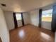 Bright bedroom with laminate flooring, two windows, and a closet at 635 W Tarpon Nw Blvd, Port Charlotte, FL 33952