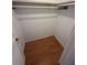 A walk-in closet with wood-look flooring and a white shelf and hanging rod at 635 W Tarpon Nw Blvd, Port Charlotte, FL 33952
