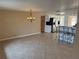 Open concept dining and kitchen area with tile floors, breakfast bar, and stainless steel appliances at 635 W Tarpon Nw Blvd, Port Charlotte, FL 33952