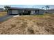 A single-story home is pictured, complete with a garage, tidy landscaping, and a welcoming front entry at 635 W Tarpon Nw Blvd, Port Charlotte, FL 33952