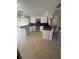 Well-lit kitchen features modern white cabinets, black countertops, and a breakfast bar at 635 W Tarpon Nw Blvd, Port Charlotte, FL 33952