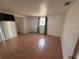 Living room featuring wood-look floors, natural light, and access to other rooms at 635 W Tarpon Nw Blvd, Port Charlotte, FL 33952