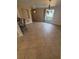 Open living room with neutral paint, ceramic floors, and large window offering natural light at 635 W Tarpon Nw Blvd, Port Charlotte, FL 33952