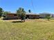 The backyard of this home has trees and a large green yard at 700 Dolphin Pkwy, Punta Gorda, FL 33950