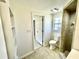 A clean bathroom featuring a walk-in shower and a toilet adjacent to the doorway at 700 Dolphin Pkwy, Punta Gorda, FL 33950