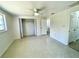 This bedroom features neutral colors, terrazzo flooring, a ceiling fan, and a closet at 700 Dolphin Pkwy, Punta Gorda, FL 33950