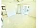 Bright bedroom boasts polished floors, a ceiling fan, and access to the bathroom and porch at 700 Dolphin Pkwy, Punta Gorda, FL 33950