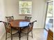 Bright eat-in kitchen features tile flooring, wood cabinets, stainless-steel dishwasher, and a backyard view at 700 Dolphin Pkwy, Punta Gorda, FL 33950