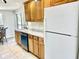 Bright kitchen features tile flooring, wood cabinets, and a stainless-steel dishwasher at 700 Dolphin Pkwy, Punta Gorda, FL 33950