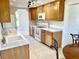 Bright kitchen features tile flooring, wood cabinets, and white appliances at 700 Dolphin Pkwy, Punta Gorda, FL 33950