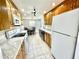 Eat-in kitchen with wooden cabinets, stone counters, and modern appliances at 700 Dolphin Pkwy, Punta Gorda, FL 33950