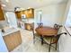 Bright kitchen features tile flooring, wood cabinets, white appliances, and an eat-in area at 700 Dolphin Pkwy, Punta Gorda, FL 33950
