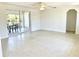 Open-concept living space with terrazzo floors and access to screened porch at 700 Dolphin Pkwy, Punta Gorda, FL 33950