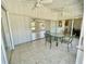 Covered patio with tile flooring, ceiling fans, and sliding glass doors that open to the living room at 700 Dolphin Pkwy, Punta Gorda, FL 33950