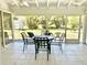 Enclosed porch featuring tiled floor, ceiling fans, and views of the lawn at 700 Dolphin Pkwy, Punta Gorda, FL 33950