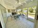 Covered porch boasts tiled floors and outdoor seating, creating a relaxing extension of the home at 700 Dolphin Pkwy, Punta Gorda, FL 33950